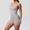 Detail view of grey yoga set featuring side pocket on high-waist shorts and slim tank top - S / Top And Bottom - Frost Gray