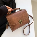 Vintage brown leather handbag with floral embossing and bronze hardware detail - Brown