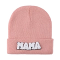Close-up of pink knit beanie with MAMA towel embroidery on folded cuff against white background - Lotus Pink