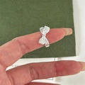 Detailed close-up of a 925 sterling silver bow knot ring worn on a finger - Silver Bowknot Fashion Style(JZ0717)