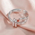 Minimalist silver multi-layer spring ring with twist knot on pink silk fabric - JZ657 Triple Loop Knot / Silver
