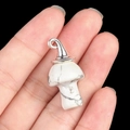 Natural white agate mushroom pendant with silver metal clasp on a dark background - Gun Black Cap / Howlite