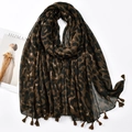 Detail of leopard print scarf with soft tassels beside a magazine and dried flowers - Classic Brown Black Leopard (XB1068-02)