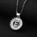 Macro view of silver-tone letter E pendant with cubic zirconia and stainless steel chain - Silver Letter E