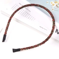 Sparkly red and green glitter headband with protective end caps on a fashion magazine - Red & Green