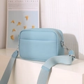 Détail du sac photo bleu clair en cuir à motif litchi avec large bandoulière en tissu - Bleu Ciel