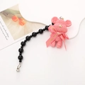 Pink knitted bear charm with a LOVE IS ribbon bow and a black beaded lanyard strap - Pink Wool Bear