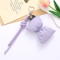 Detail of purple PU leather bow charm with heart-shaped metal clasp and tulip decor - Purple