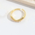Minimalist gold V-shape open ring with small white pearls on a textured background - Arc Pearl
