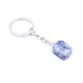 Macro shot of polished blue natural crystal stone keychain with silver metal ring - Blue Spot Stone