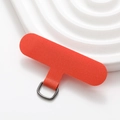 Macro shot of durable orange fabric phone lanyard tab with a metal D-ring attachment - Orange Red