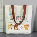 White canvas tote bag with brown handles featuring cute cartoon animals and text - Live Youth to the Fullest
