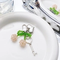 Close-up of pink crystal cherry keychain with heart and key charms on ceramic plate - Cherry Heart Lock Pendant / Pink