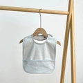 Detailed view of the gray waterproof baby silicone bib with food catcher tray - Light Blue