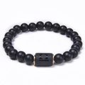 Macro view of matte black onyx Libra bracelet with rose gold plated metal spacers - Libra