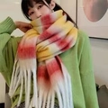 Thick rainbow scarf in yellow, red, and white gradient with fringes worn by a model - Red Yellow White Gradient Plaid