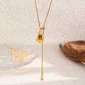 Macro detail of a golden sunflower tiger eye stone pendant necklace on a textured base - Oval Gem Tag Style (12040)