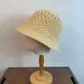 Detail view of the intricate hollow knit pattern on a cream crochet bucket sun hat - M / Apricot
