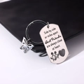 Macro detail of engraved stainless steel friendship dog tag keychain with butterfly charm - Style 23 (Butterfly Best Friends)