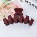 Dark red matte wave-shaped hair claw clip made of plastic on a white background - Burgundy