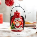 Red Christmas Santa lantern with internal LED warm light and miniature green tree - Cylindrical Santa Claus Portable Lantern
