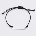 Macro shot of silver-tone stainless steel bar on black woven bracelet with smooth finish - Standard (MP633) / Steel