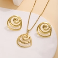 Close-up of golden spiral jewelry set featuring circular earrings and necklace on white podium - Spiral Vortex Disc Style (E3786-2)