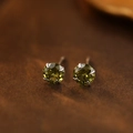 S999 sterling silver stud earrings featuring olive green gemstones in a four-prong setting - August Peridot