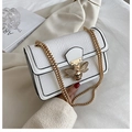 White faux-crocodile crossbody bag with rhinestone bee buckle and gold chain strap - White