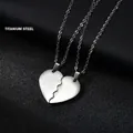 Macro shot of two silver titanium puzzle heart pendants for couples on black leather - Glossy / Steel Color (Couple Set)