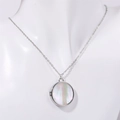 Silver round locket necklace with butterfly shell inlay on a white jewelry bust - Round / Silver