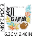 Detail of flower and teapot embroidered patch with ES AMOR text on white background - ES AMOR Heart Teapot