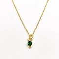 Detailed macro view of owl pendant with green gemstone and white zircon in gold finish - With Necklace / Dark Green