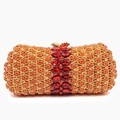 Detail of orange rhinestone evening clutch bag with gold trim and large red crystal stone - Orange Red