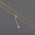 Detailed close-up of the 18k gold lobster clasp with an adjustable chain and crystal bead - Gold Thin Chain