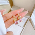 Detail of pink zircon flower earrings with a rectangular gemstone in a gold setting - Pink Rectangular Gemstone Flower Stud Earrings (D508)