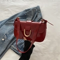 Chic burgundy patent leather shoulder bag with gold horseshoe buckle and retro vibe - Red