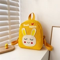 Close-up of bright yellow canvas kid's backpack featuring Small Rabbit print and top handle - Yellow