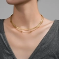 Double-layered golden stainless steel necklace with herringbone chain and oval beads - Gold Layered Snake & Rice Bead Chain