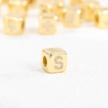 Macro shot of gold-plated cube bead featuring a sparkling cubic zirconia inlaid letter S - S (Single Pendant)