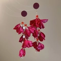 Macro detail of red floral tassel earrings with fabric petals and gold chain links - Red Tassel Forest Style