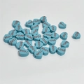 Macro shot of 10mm teal heart-shaped clay beads with LOVE lettering for DIY jewelry - Blue