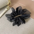 Detail of elegant black organza flower hair clip with a gold metal center bar accent - Versatile Black