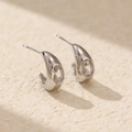Paia di orecchini a C in argento S925 con gemme ovali trasparenti su sfondo beige - Argento 925 / Oro Bianco