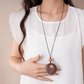 Detail der hölzernen Kette mit rundem Anhänger und brauner Perle an schwarzer Schnur - Kaffee Ring Stil (8#)