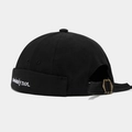 Detail of black Miki hat featuring white embroidery and an adjustable bronze metal buckle - Black
