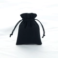 Small black velvet drawstring jewelry pouch with a soft texture for elegant storage - Black