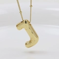 Detailed close-up of golden balloon style J letter pendant necklace on a chain - Letter J (Necklace)