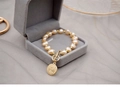 Detailed macro view of baroque pearl bracelet with gold coin pendant in a velvet box - 15-16cm (Wrist Circumference) / Queen Pendant Style / Pink