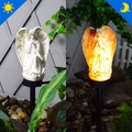Solar powered white angel garden statue showing day and night warm light comparison - White Angel